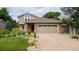 Charming home with brick accents, a two-car garage, and a well-manicured lawn at 8167 S Wabash Ct, Centennial, CO 80112