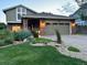 Charming exterior view showcasing a well-lit home and manicured front yard at 8167 S Wabash Ct, Centennial, CO 80112