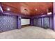 Home theater room with a large screen, projector, and unique purple accents at 8167 S Wabash Ct, Centennial, CO 80112