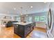 Open kitchen with a large island, modern appliances, and seamless access to the living area at 8167 S Wabash Ct, Centennial, CO 80112