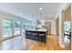 Modern kitchen featuring a large island with seating, stainless steel appliances, and a sliding glass door at 8167 S Wabash Ct, Centennial, CO 80112