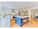 Stylish kitchen featuring a large island, stainless steel appliances, and white cabinetry at 8167 S Wabash Ct, Centennial, CO 80112