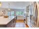 Bright, updated kitchen with stainless appliances, white cabinetry, and large island at 8167 S Wabash Ct, Centennial, CO 80112