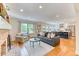 Open-concept living room flows into a modern kitchen with stainless steel appliances at 8167 S Wabash Ct, Centennial, CO 80112