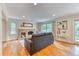Cozy living room featuring a brick fireplace, hardwood flooring, and natural light at 8167 S Wabash Ct, Centennial, CO 80112
