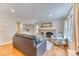 Cozy living room featuring a brick fireplace, hardwood flooring, and natural light at 8167 S Wabash Ct, Centennial, CO 80112