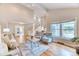 Inviting living space with large windows, a cozy seating area, and open access to the staircase at 8167 S Wabash Ct, Centennial, CO 80112