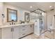 Luxurious main bathroom with double vanity, glass shower, and elegant tile work at 8167 S Wabash Ct, Centennial, CO 80112