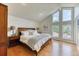 Sun-filled main bedroom with large windows, hardwood floors, and a vaulted ceiling at 8167 S Wabash Ct, Centennial, CO 80112