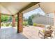 Covered patio with brick pillars and stone flooring, offering a cozy outdoor seating area at 8167 S Wabash Ct, Centennial, CO 80112