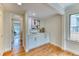 Charming wet bar area with white cabinetry and wood floors in a naturally lit room at 8167 S Wabash Ct, Centennial, CO 80112