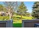 View of the backyard with a fence, trees, and grassy area at 2645 S Xanadu Way # C, Aurora, CO 80014