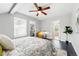 Bright bedroom features a ceiling fan, neutral walls, and dark wood floors at 2645 S Xanadu Way # C, Aurora, CO 80014