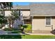 View of the exterior of the townhome with walkway, lawn and mature trees at 2645 S Xanadu Way # C, Aurora, CO 80014