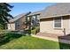 Exterior side view of townhome with well maintained grassy lawn and landscape at 2645 S Xanadu Way # C, Aurora, CO 80014