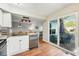 Open concept kitchen with stainless dishwasher, granite countertops, and sliding doors to the outdoor patio at 2645 S Xanadu Way # C, Aurora, CO 80014