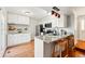 Modern kitchen with white cabinets, stainless steel appliances, granite countertops, and a breakfast bar at 2645 S Xanadu Way # C, Aurora, CO 80014