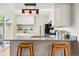 Stylish kitchen with a granite countertop, modern lighting, and wicker barstools at 2645 S Xanadu Way # C, Aurora, CO 80014