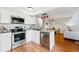 A modern kitchen seamlessly connects to the living area, featuring stainless appliances and ample countertop space at 2645 S Xanadu Way # C, Aurora, CO 80014