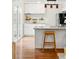 Bright kitchen featuring white cabinets, granite countertops, and a stylish island with bar stool seating at 2645 S Xanadu Way # C, Aurora, CO 80014