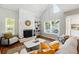Cozy living room showcasing the stone fireplace and ample natural light at 2645 S Xanadu Way # C, Aurora, CO 80014