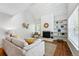 Bright living room with a stone fireplace, built-in shelves, and wood floors at 2645 S Xanadu Way # C, Aurora, CO 80014
