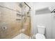 Tile shower with glass doors with built in shelving and shower head at 2645 S Xanadu Way # C, Aurora, CO 80014