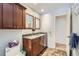 Bathroom with a dual sink vanity, dark cabinets, and tile flooring at 15341 E Arkansas Pl, Aurora, CO 80017