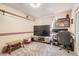 Bedroom with a built in desk, TV, and lots of natural light at 15341 E Arkansas Pl, Aurora, CO 80017