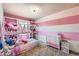 Pink and white bedroom with a full bed, shelving, and lots of natural light at 15341 E Arkansas Pl, Aurora, CO 80017