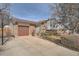 Charming split-level home featuring a brick facade, two-car garage, and well-maintained landscaping at 15341 E Arkansas Pl, Aurora, CO 80017