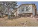 A split level home with brick facade, manicured lawn and minimal shrubs in a well established neighborhood at 15341 E Arkansas Pl, Aurora, CO 80017