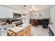 Functional kitchen with white cabinetry, stainless appliances, adjacent to breakfast area at 15341 E Arkansas Pl, Aurora, CO 80017