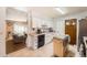 Bright kitchen with white cabinetry and stainless appliances, view from living room at 15341 E Arkansas Pl, Aurora, CO 80017