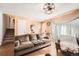 Cozy living room featuring wood floors, staircase to upstairs, and large window with a view to front yard at 15341 E Arkansas Pl, Aurora, CO 80017