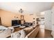 Comfortable living room with wood floors, neutral paint and large sectional sofa, adjacent to updated kitchen at 15341 E Arkansas Pl, Aurora, CO 80017