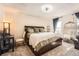 Cozy main bedroom with a decorative accent wall, full bed, and lots of natural light at 15341 E Arkansas Pl, Aurora, CO 80017