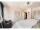 Well-lit main bedroom featuring plush carpet, a relaxing chair, and neutral walls at 15341 E Arkansas Pl, Aurora, CO 80017