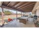 Covered patio featuring a pool table, swing, grill, and outdoor seating set, creating an ideal entertainment space at 15341 E Arkansas Pl, Aurora, CO 80017