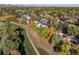 Aerial view of homes in the community featuring mature trees and a walking path with neighborhood access at 5374 W Canyon Trl # B, Littleton, CO 80128