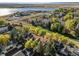 A beautiful aerial view of townhomes showcases vibrant fall foliage near a serene lake and community at 5374 W Canyon Trl # B, Littleton, CO 80128