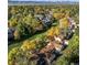 An aerial view of the community in the fall shows a walking path, golf course, and view of the mountains at 5374 W Canyon Trl # B, Littleton, CO 80128