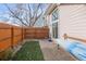 Backyard featuring wooden fence, patio, bench, artificial grass and access to the home at 5374 W Canyon Trl # B, Littleton, CO 80128