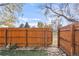 Backyard featuring wooden fence, stone pathway, and access to the community park at 5374 W Canyon Trl # B, Littleton, CO 80128