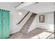 Carpeted staircase with stylish turquoise cabinet at 5374 W Canyon Trl # B, Littleton, CO 80128