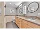 Modern bathroom featuring double vanity, granite countertops, mosaic tile accents, and updated fixtures at 1860 N Washington St # 212, Denver, CO 80203