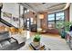 Living room featuring hardwood floors, a fireplace, and large windows offering plenty of natural light at 1860 N Washington St # 212, Denver, CO 80203