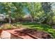 Backyard brick path with a well maintained lawn with mature trees in the background at 7844 S Eudora Cir, Centennial, CO 80122