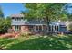 Back of the house has a brick patio with mature trees shading the large manicured lawn at 7844 S Eudora Cir, Centennial, CO 80122