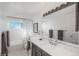 Elegant bathroom with a large mirror, single sink vanity, and a shower over tub with modern fixtures at 7844 S Eudora Cir, Centennial, CO 80122